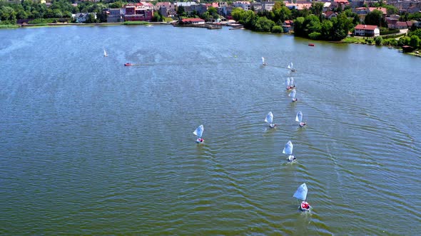 Regatta of white boats on the lake, view from above