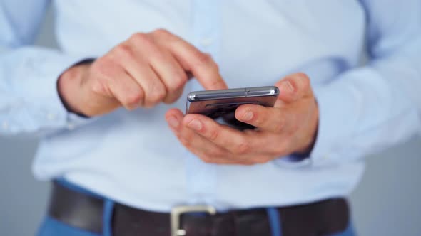 Formally Dressed Man Using Smartphone for Serfing on Internet Close-up