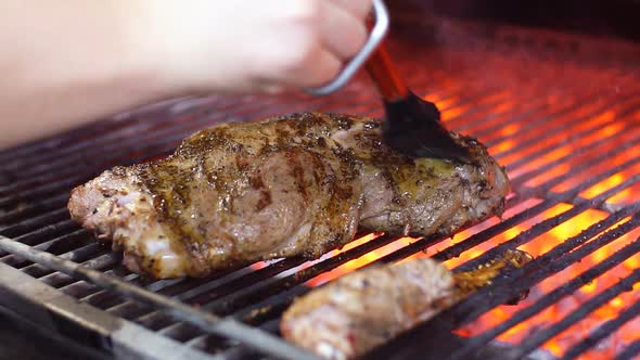 Cooking Delicious Juicy Meat Steaks on the Grill on Fire