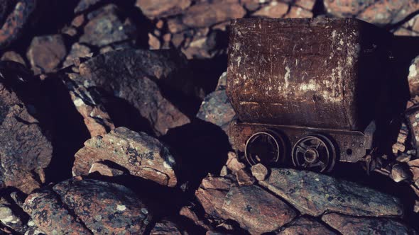 Abandoned Rusty Mine Cart on Rocks alt