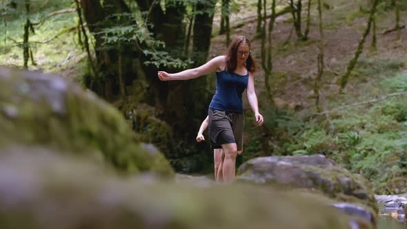 Woman and a Boy Walking Carefully in Forest