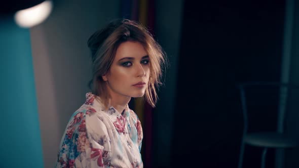 CU Portrait of Young Charming Girl Who Looks at the Camera Wearing a Dress with Flowers