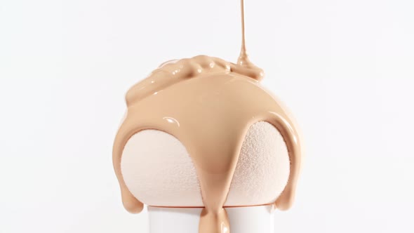 Makeup Liquid Beige Foundation Pouring on Sponge Closeup