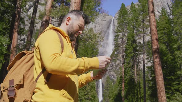 Tourists with Backpack Lifestyle Hiking in Green Forest at Yosemite Waterfall 6K