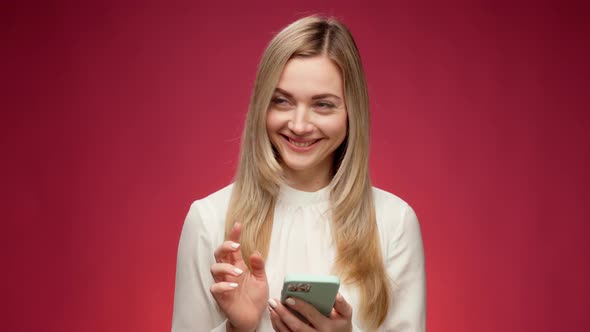 Young Woman Using Her Smartphone in Studio
