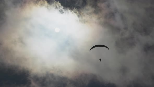 Paragliding Adventure Sport Against Bright Sun on Cloudy Sky