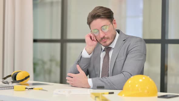 Sleepy Middle Aged Engineer Taking Nap While Sitting in Office