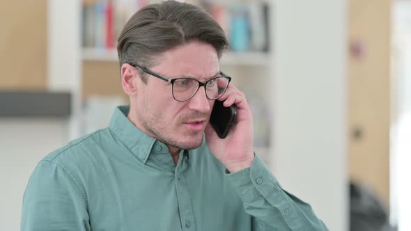 Angry Middle Aged Man Fighting During Phone Talk