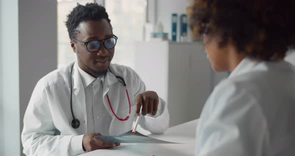 African Young Medical Specialists Discuss Chest Xrays in Clinic Office