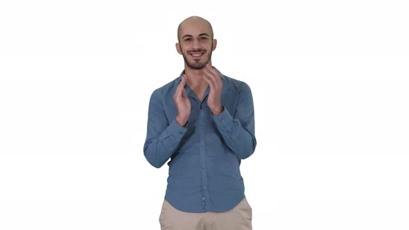 Young Arabic Man Standing Claps His Hands Smiling on White Background