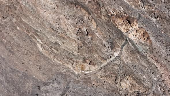 Pakistani trucks travel on dangerous paved road along the mountain, transport goods via Karakoram hi