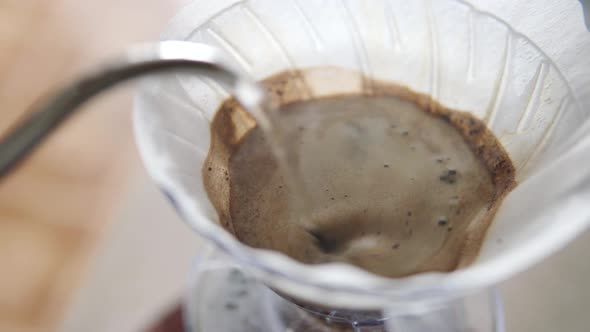 Barista Pours Hot Water Into the Funnel Wets the Paper Filter