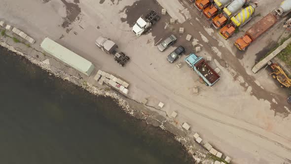 Overhead Top Down Aerial View Following a Truck Without a Trailer Arriving Into the Harbor Parking