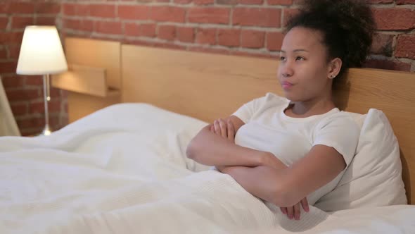 African Woman Thinking While Sitting in Bed