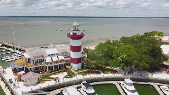 A wide drone shot of the lighthouse at Harbor Town on Hilton head island, sc