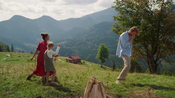 Happy Family Funny Dancing on Mountain Hill