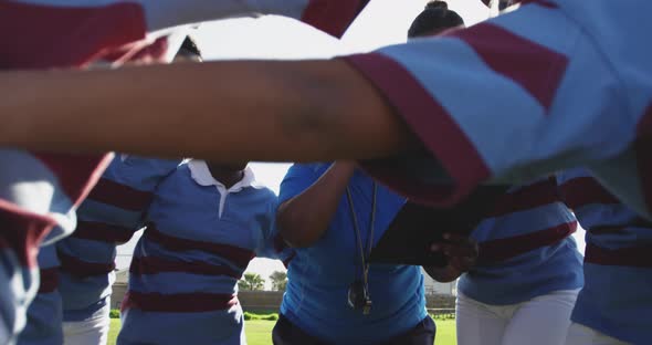 Young adult female rugby team and coach