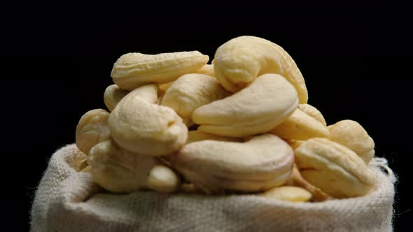 Cashew nuts rotation on black background, Close up.