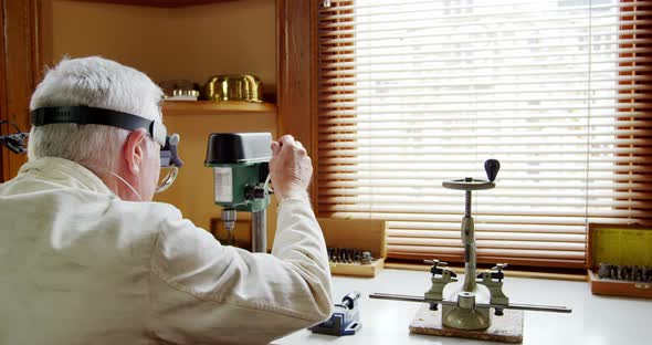 Horologist repairing a watch