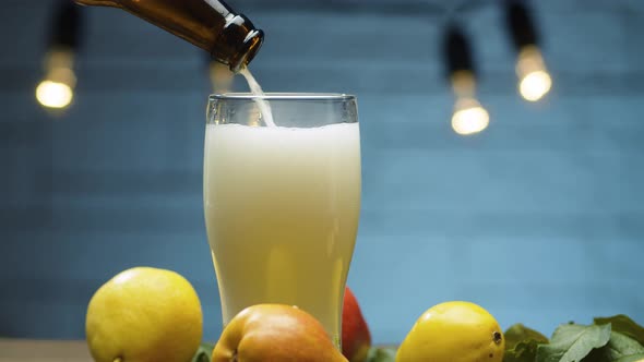 Pear cider pouring into a glass