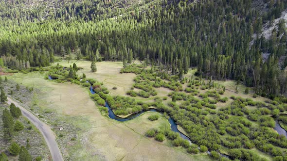 Aerial Of A Winding River Through A Meadow