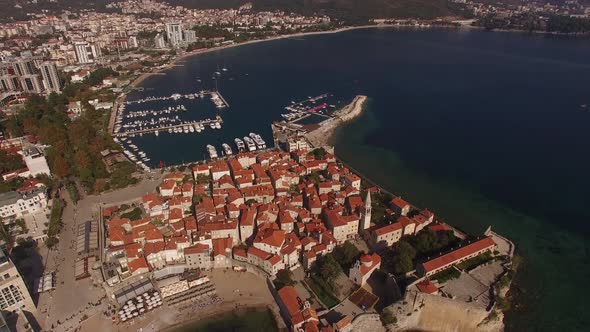 Old Town of Budva on the Peninsula with a Boat Dock