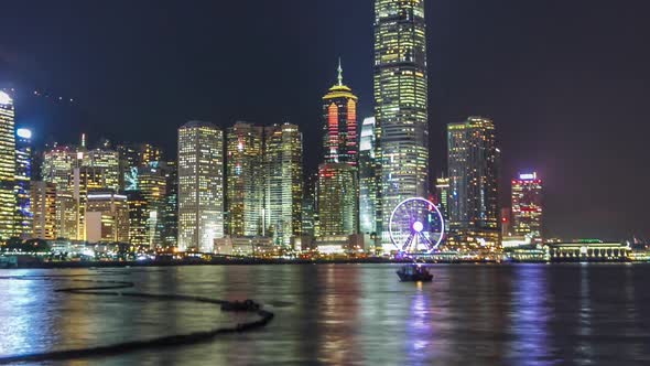 Hong Kong China Skyline Panorama with Skyscrapers at Night From Across Victoria Harbor Timelapse