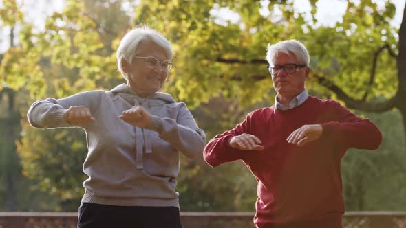 Elderly Caucasian Couple Doing Sports Together in the Park Selective Focus Medium Shot