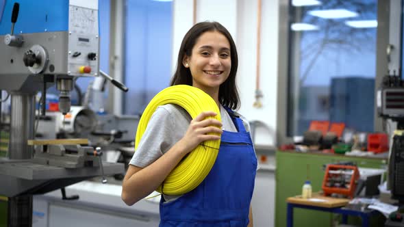 Apprentice with yellow cables in factory