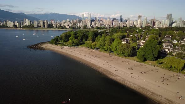 People Practicing Social Distancing On The Kitsilano Beach With English Bay Beach And Downtown Skyli