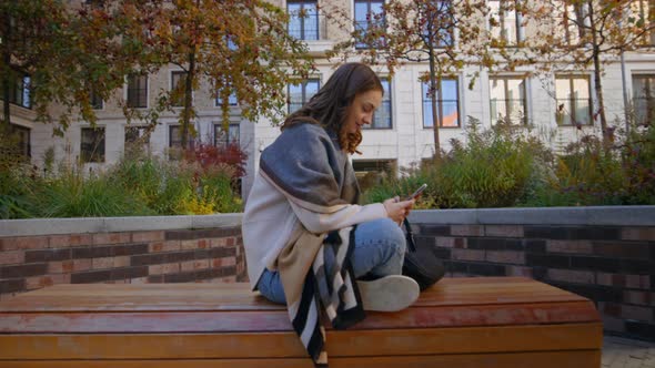 Young Happy Woman Outdoors Use Smartphone