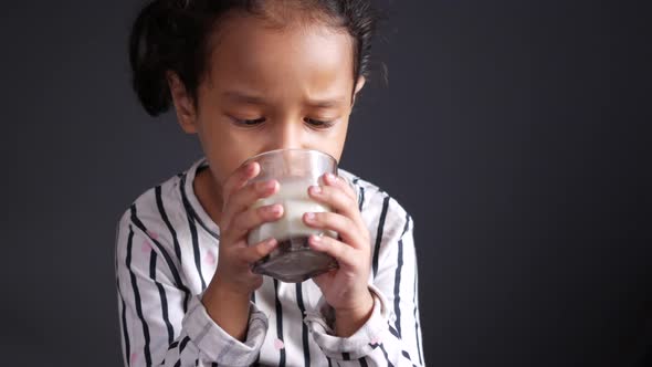 Child Girl Drinking Milk While Sited