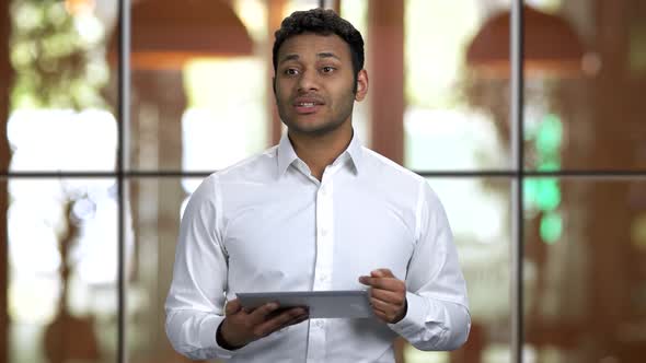 Portrait of a Young Hindu Man Giving Speech Holding Tablet Pc