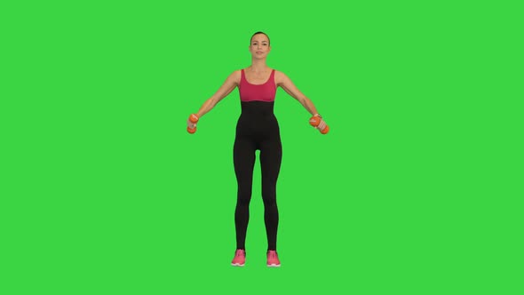 Fitness Girl Doing Exercise with Dumbbells on a Green Screen Chroma Key