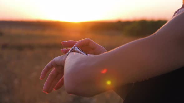 Young Woman Runner Looking at Sports Smart Watch, Checking Performance or Heart Rate Pulse Trace