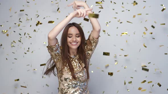 Celebration. Happy Woman Dancing With Confetti On White