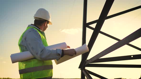 Architect Worker Checking Construction Project On Electric Tower