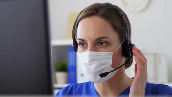 Doctor in Mask with Headset and Computer at Clinic