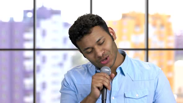 Close Up Portrait Darkskinned Man Performing Song with Microphone