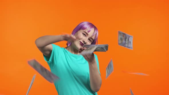 Unusual Woman with Happy Face Scatters Money