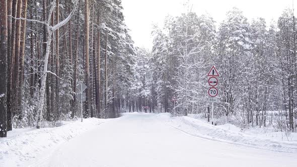 Road Signs on a Snowy Highway