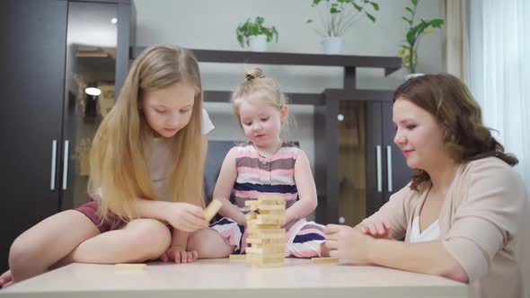Mom and Daughters Play Blocks