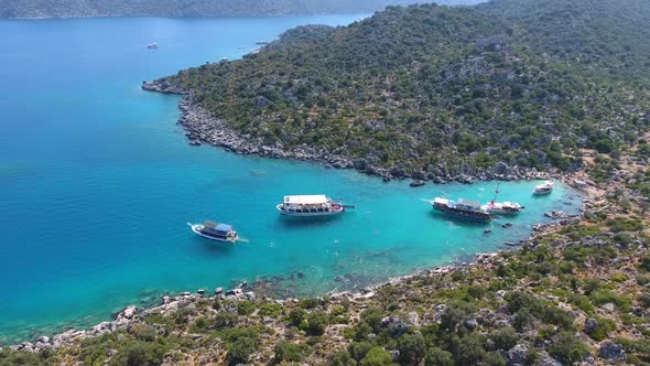 Diving Tour Boats Anchored in a Small Bay in Turkey and Tourists Vacationers Swimming in the Sea