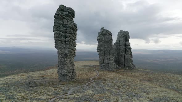 High rocks rising up on cloudy sky background, beauty of nature