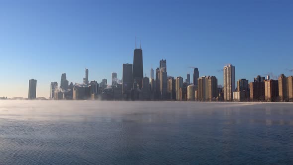 sea smoke on Lake Michigan with Chicago skyline in the morning sunlight during a polar vortex 4k