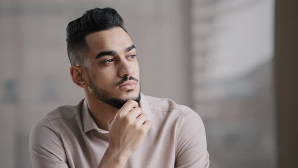 Thoughtful Serious Young Hispanic Man Guy Doubtful Male Professional Worker Sit at Home Office Desk