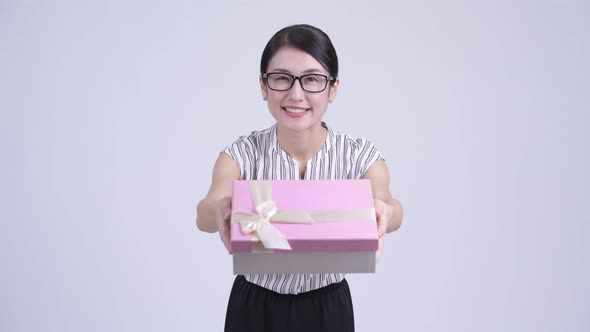 Happy Beautiful Asian Businesswoman Giving Gift Box