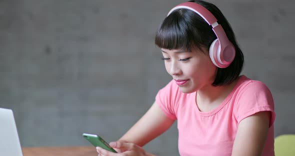 Woman enjoy music on headphone at home