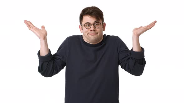 Portrait of Confused Man Wearing Black Sweatshirt and Eyeglasses Shrugging and Throwing Up Hands