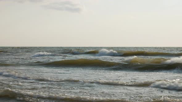 Rough waves of Baltic sea crashing on coastline on sunny day, static view